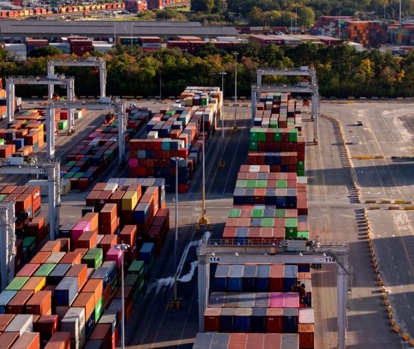 A lot filled with multicolor freight transportation boxes, suggesting global trade and economics